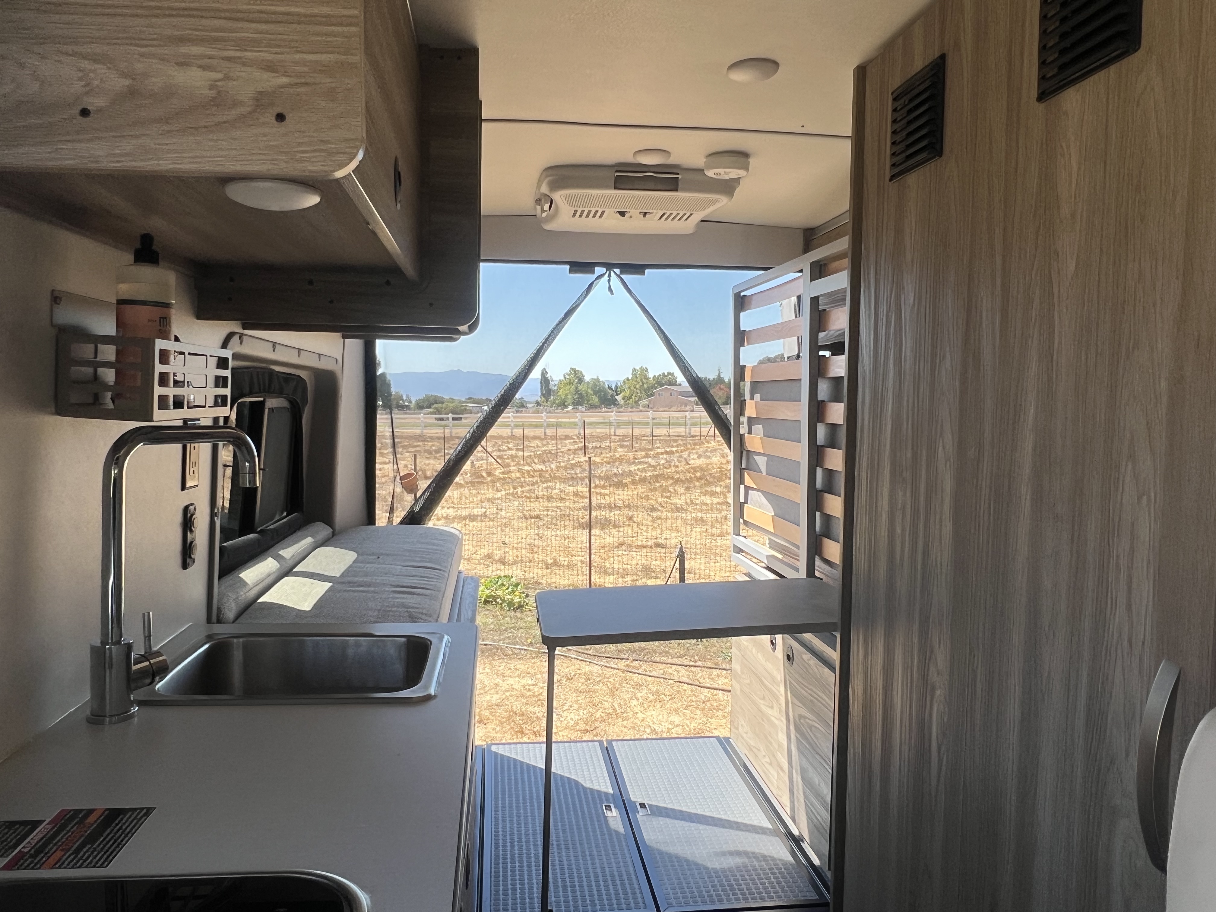 Family enjoying dinner inside the Nomadaya van